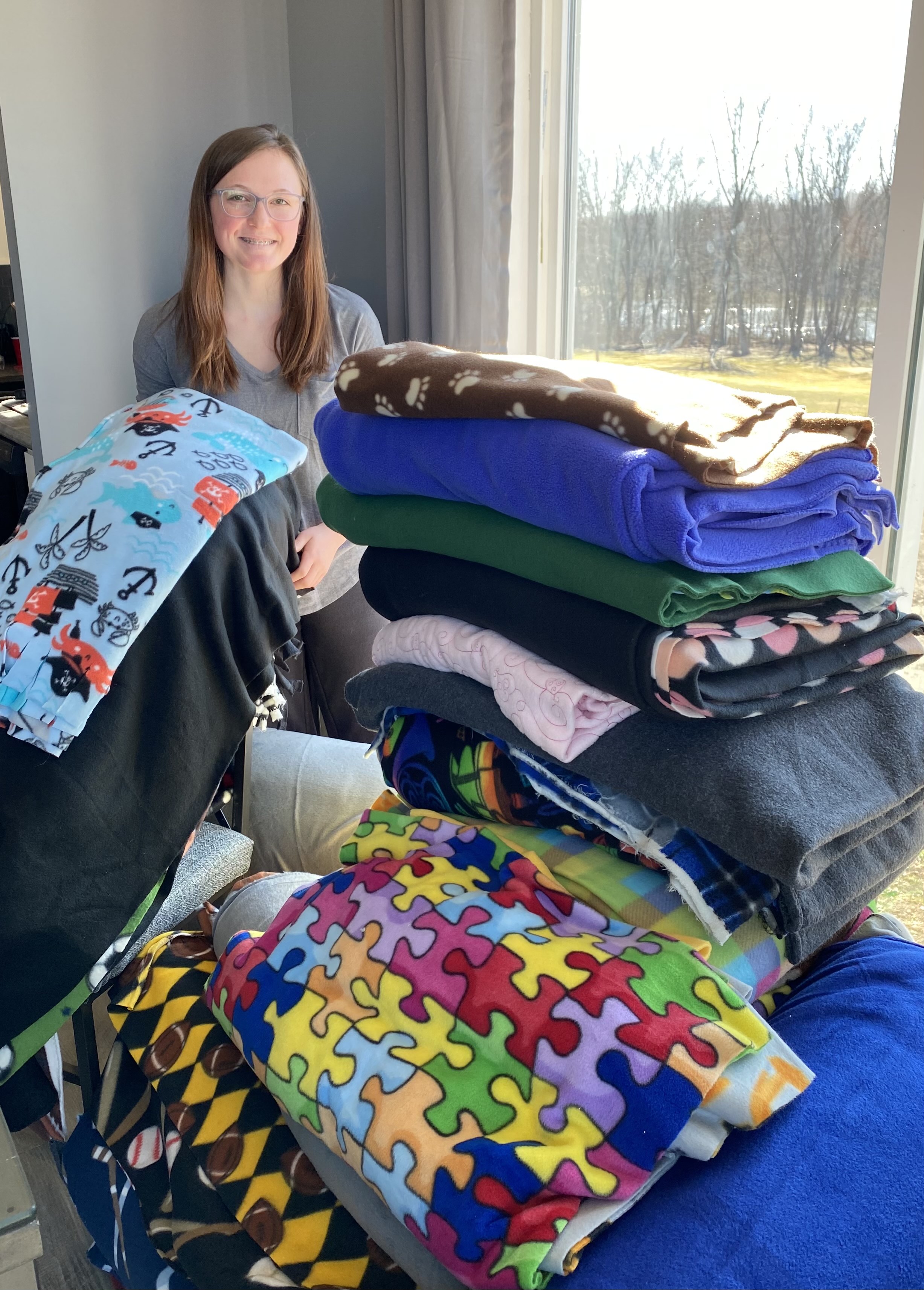 JE Senior Emily Mocyk poses with fleece, collected to turn into blankets for patients at Upstate Golisano Children's Hospital