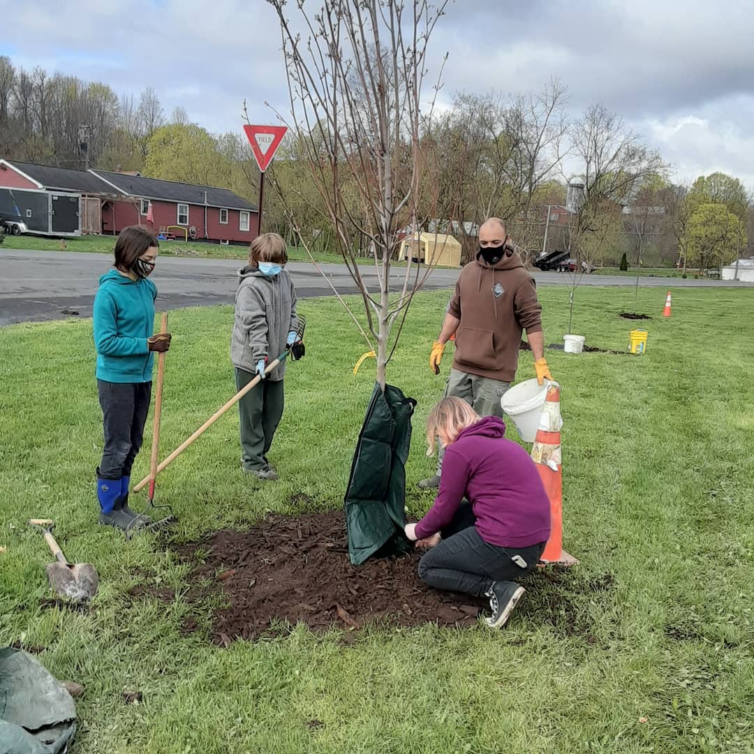 Senior Frankie Brown leads volunteers in planting trees in the village of Jordan
