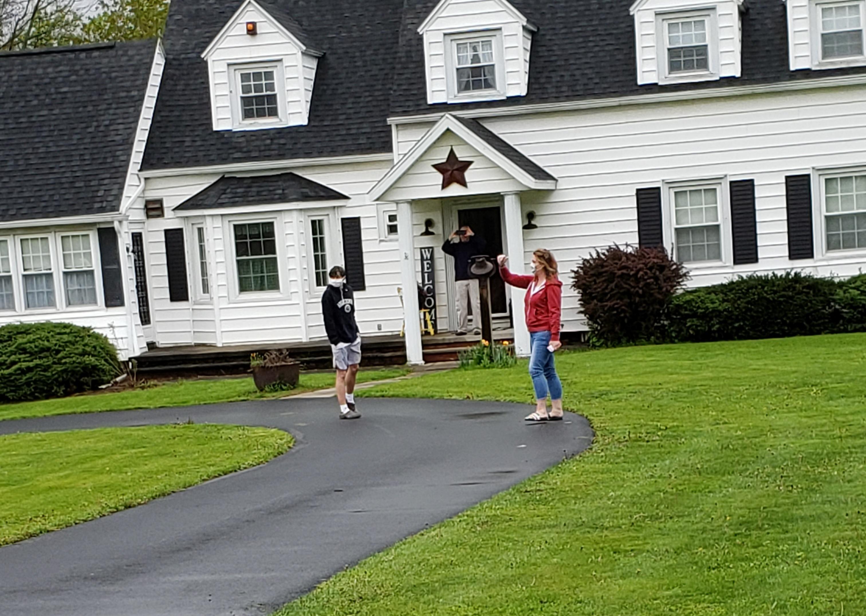 Seniors are visited by JE staff and teachers, who delivered signs for their front yards