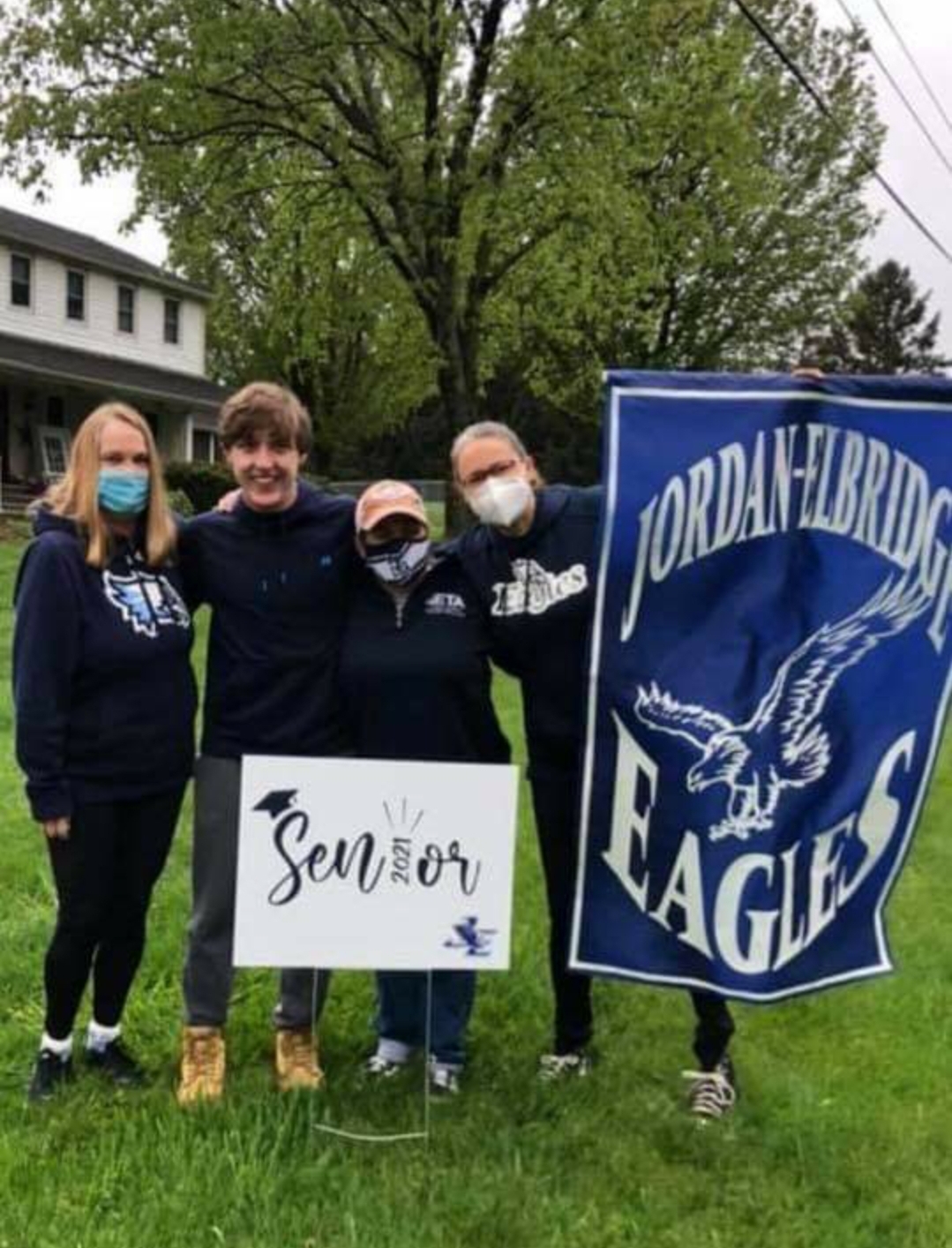 Seniors are visited by JE staff and teachers, who delivered signs for their front yards