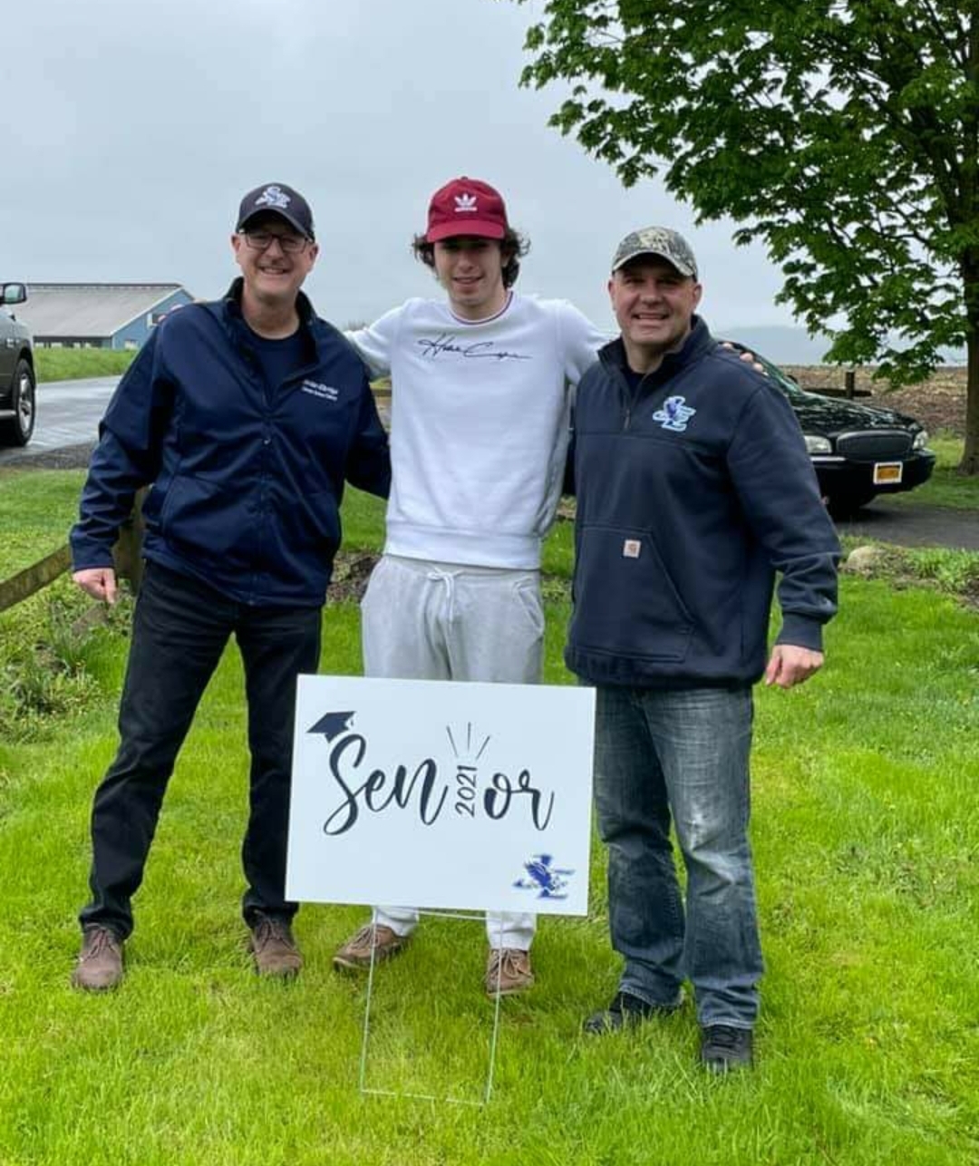 Seniors are visited by JE staff and teachers, who delivered signs for their front yards