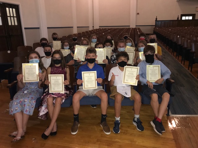 JE Middle schoolers hold up their National Junior Honor Society certificates