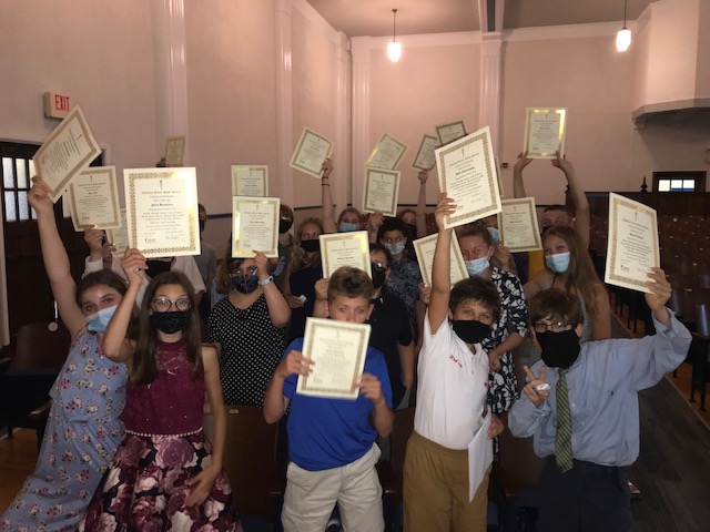 JE Middle schoolers hold up their National Junior Honor Society certificates