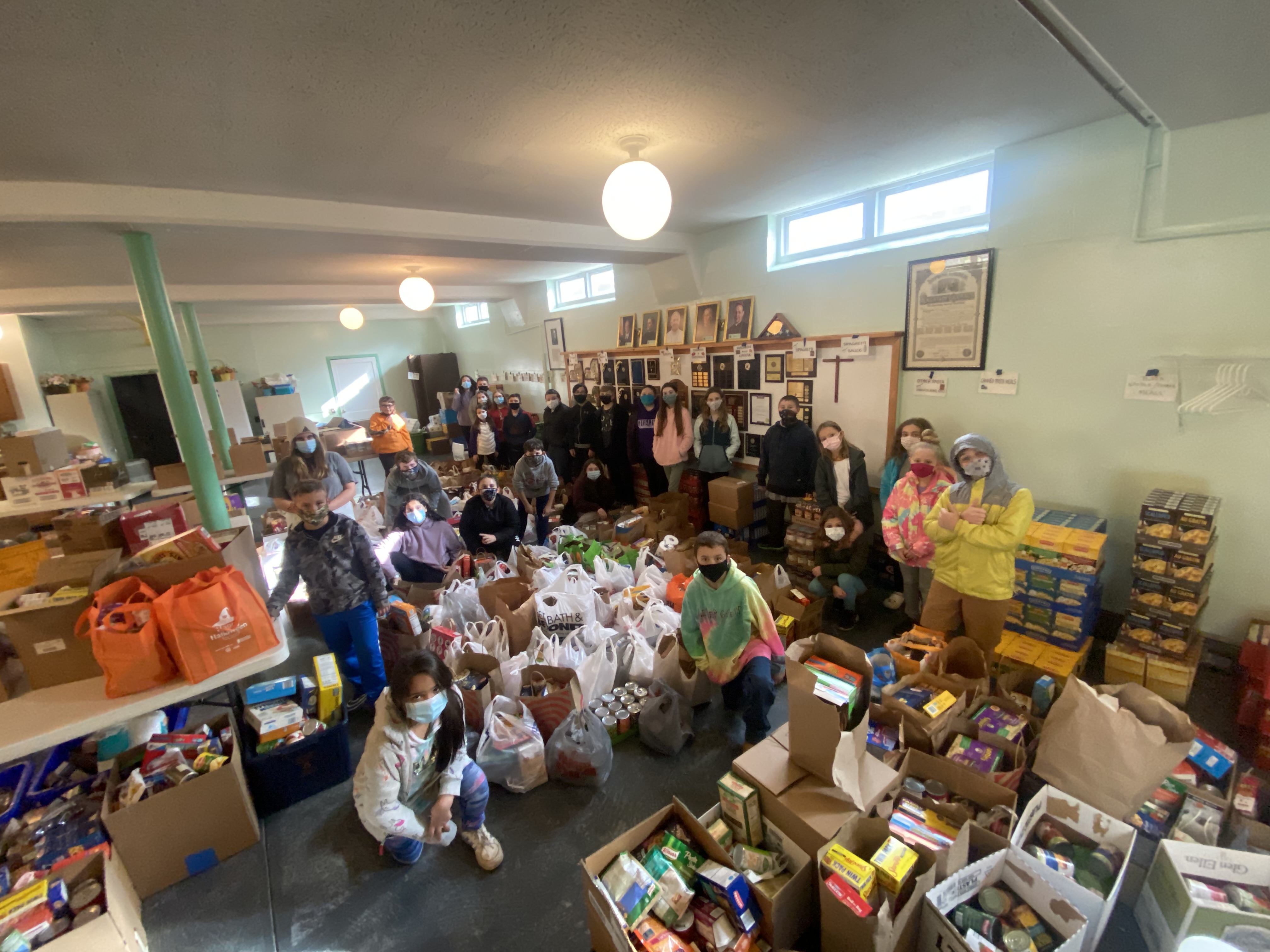 Students from JEMS and EE team up to unload donated food at the local food pantry