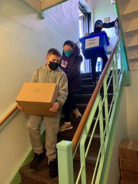 Students from JEMS and EE team up to unload donated food at the local food pantry