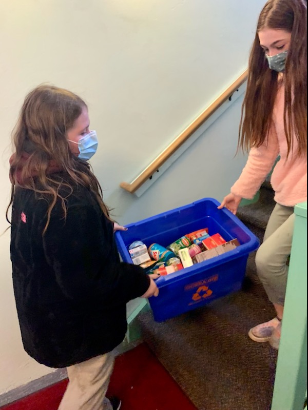 Students from JEMS and EE team up to unload donated food at the local food pantry