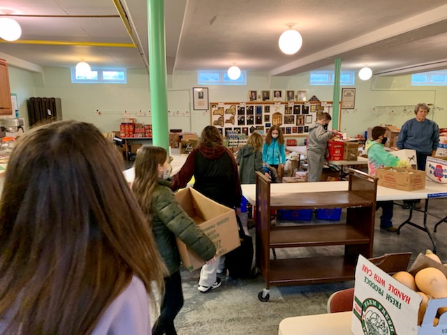 Students from JEMS and EE team up to unload donated food at the local food pantry
