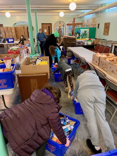 Students from JEMS and EE team up to unload donated food at the local food pantry