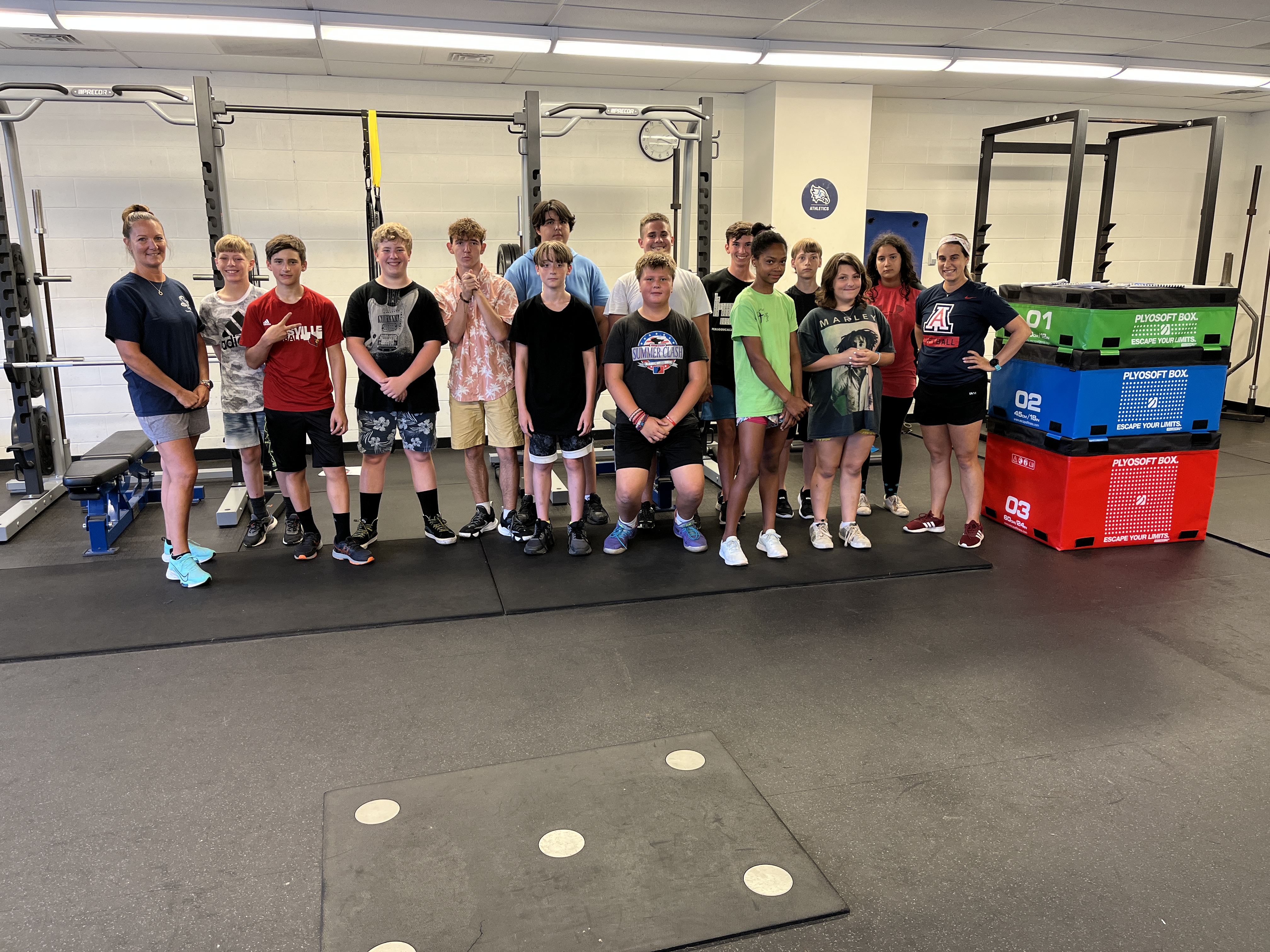 Students pose for a picture while on a break from working out at the summer health and fitness program at JEHS