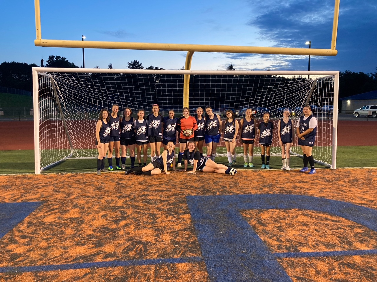 The varsity girls soccer team poses for a photo during summer play