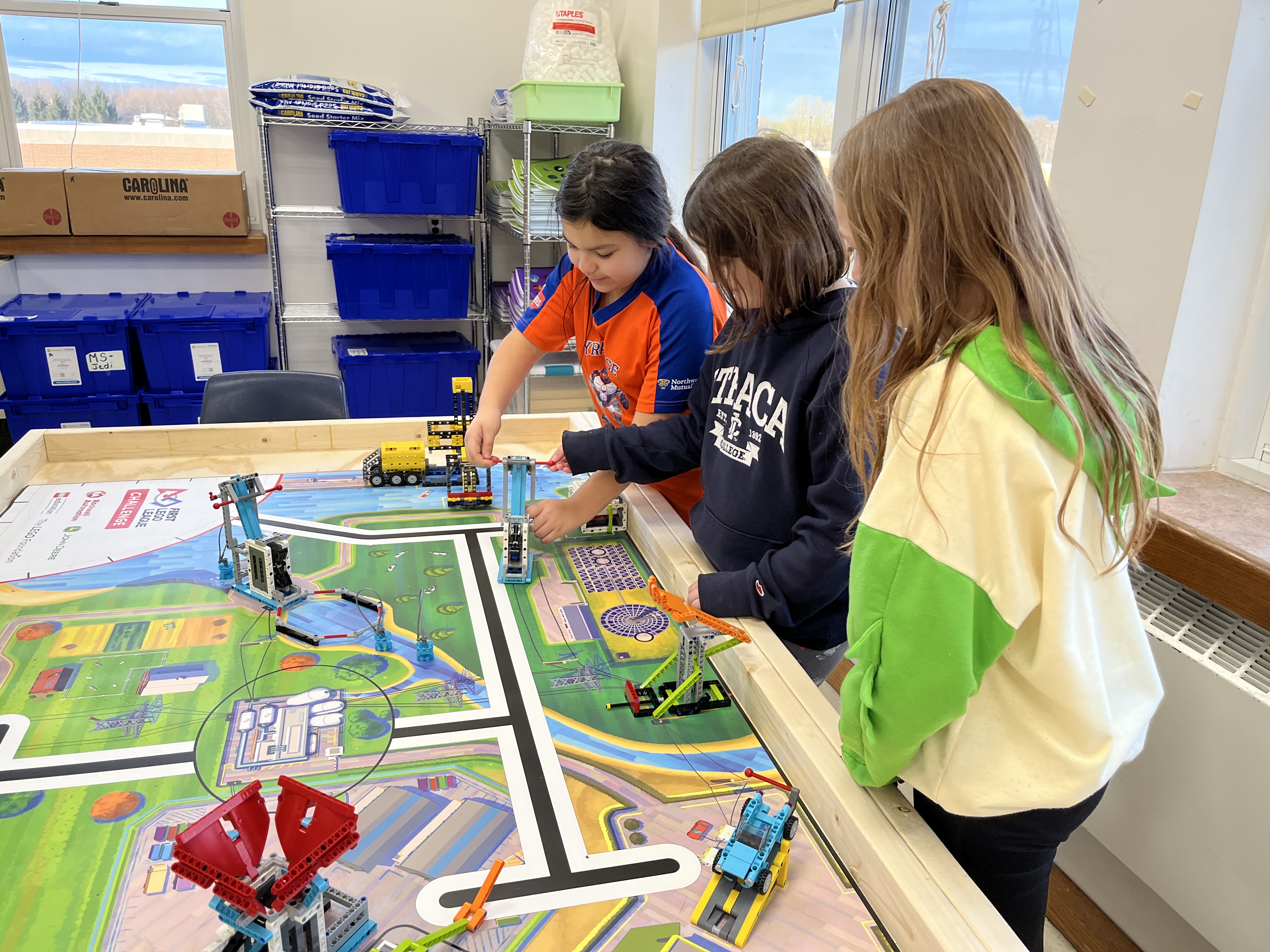 JEDIS fourth graders work on building mission pieces and coding robots in Lego League